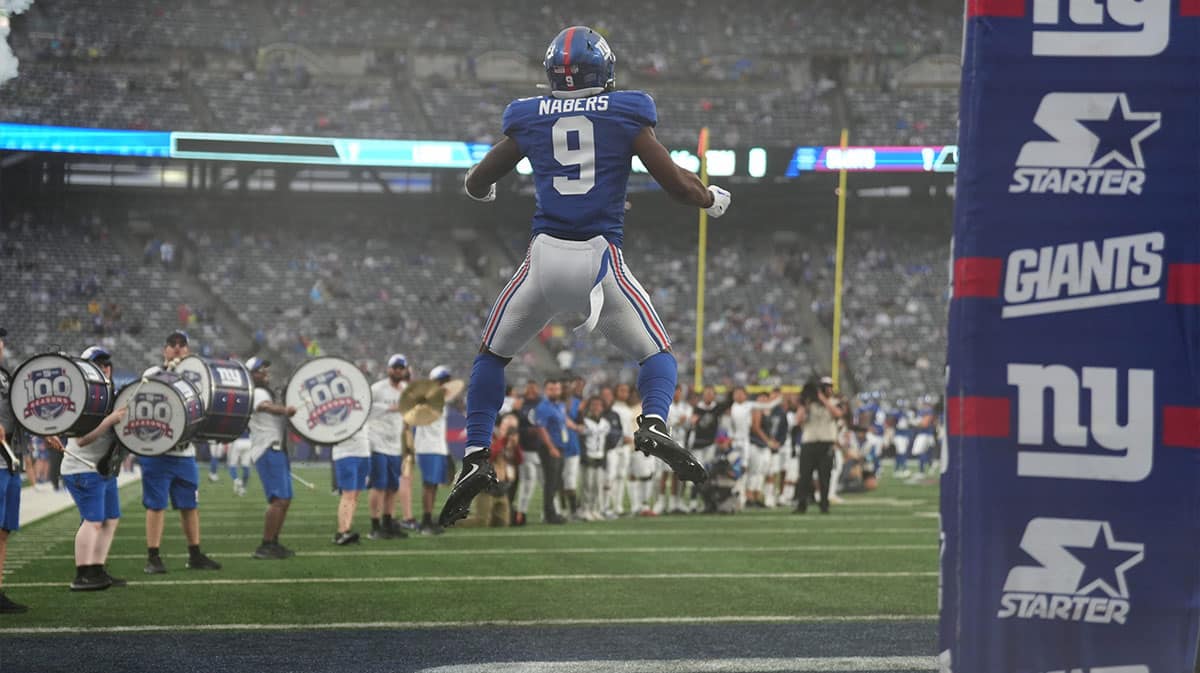 New York Giants wide receiver Malik Nabers (9) leaps into the air as he takes the field at MetLife Stadium, Thursday, August 8 2024, just before the start of the game.