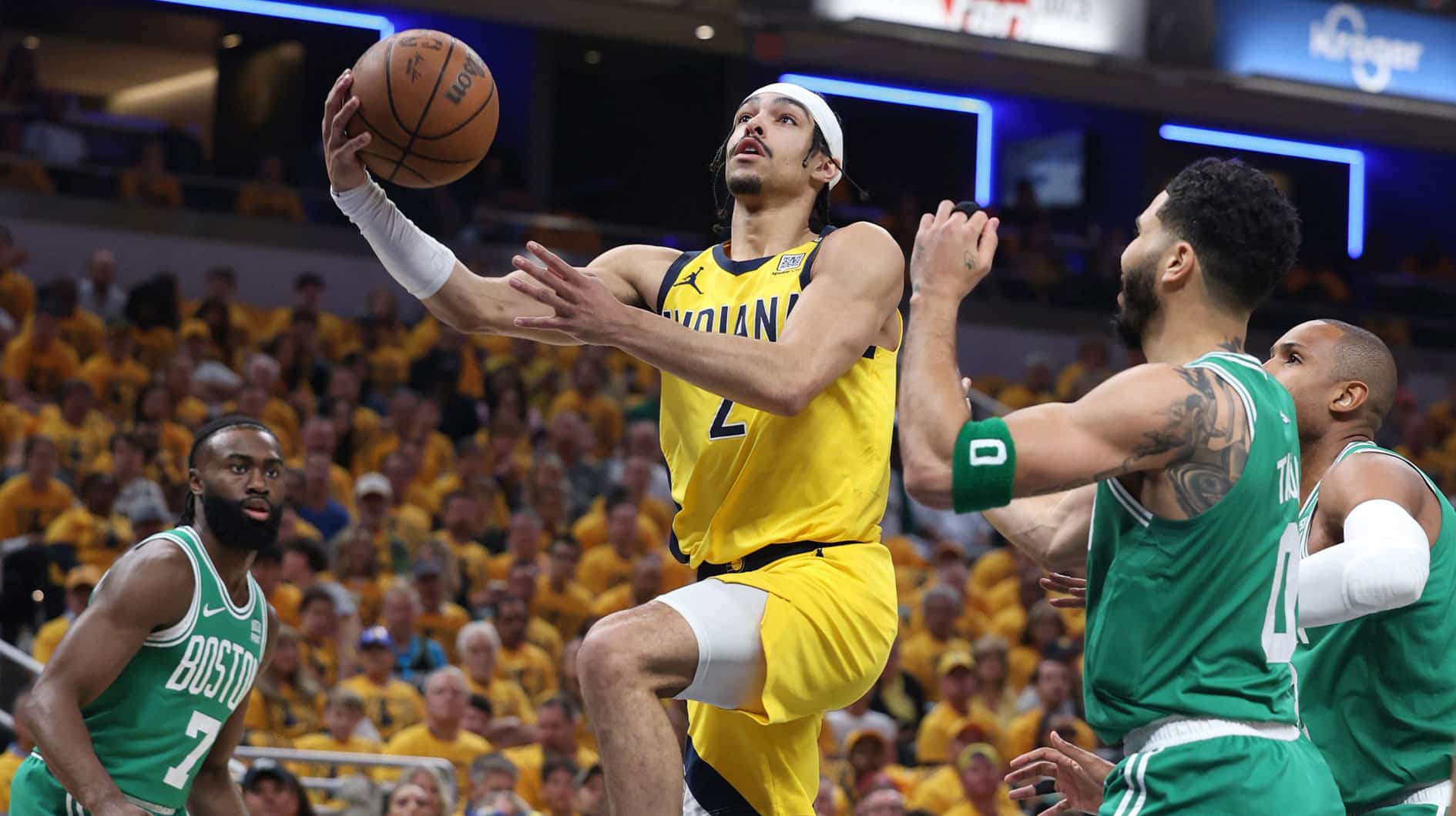 Indiana Pacers guard Andrew Nembhard (2) shoots the ball against Boston Celtics guard Jaylen Brown (7) and forward Jayson Tatum (0) and center Al Horford (42) during the first quarter of game three of the eastern conference finals in the 2024 NBA playoffs at Gainbridge Fieldhouse.