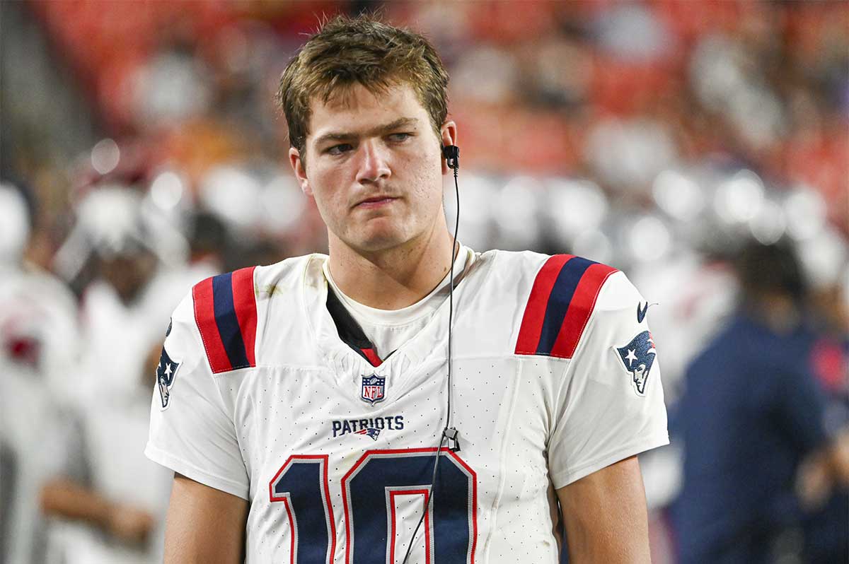 New England Patriots quarterback Drake Maye (10) stands in the bench area during the second half against the Washington Commanders at Commanders Field.