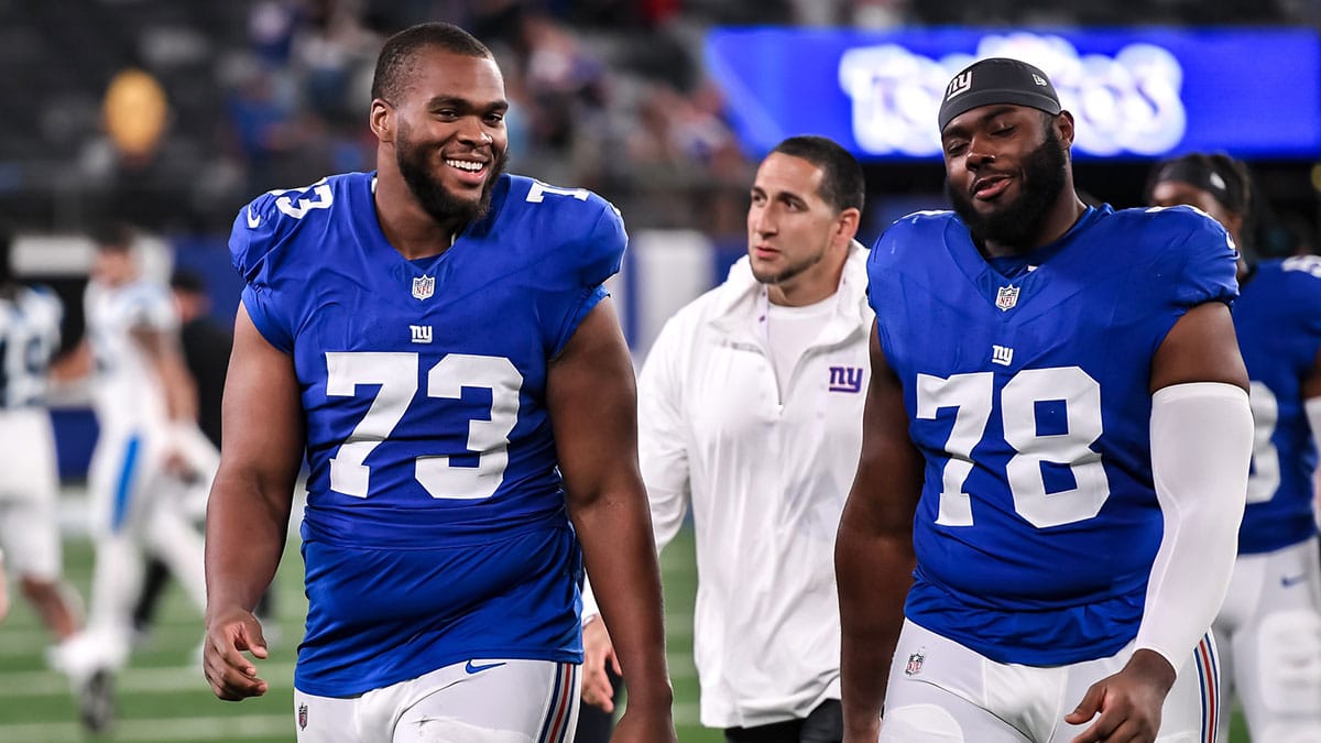 Aug 18, 2023; East Rutherford, New Jersey, USA; New York Giants offensive tackle Evan Neal (73) and New York Giants offensive tackle Andrew Thomas (78) exit the field after defeating the Carolina Panthers at MetLife Stadium. Mandatory Credit: John Jones-USA TODAY Sports