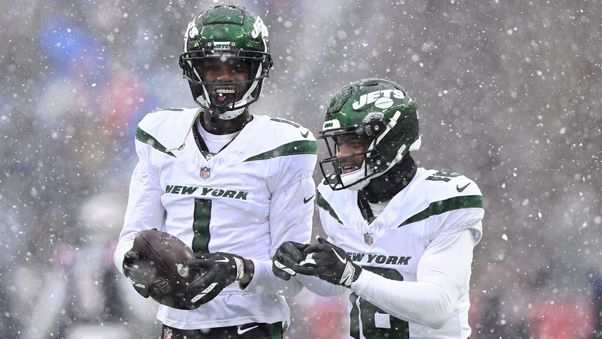 New York Jets cornerback Sauce Gardner (1) talks with wide receiver Randall Cobb (18) before a game against the New England Patriots at Gillette Stadium. 