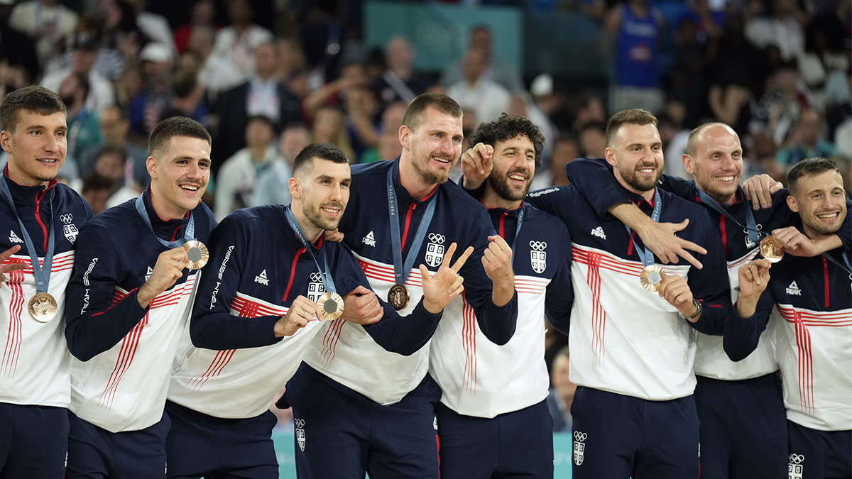 Serbia power forward Nikola Jokic (15) celebrates on the podium with teammates after winning the bronze medal in men's basketball during the Paris 2024 Olympic Summer Games at Accor Arena. 