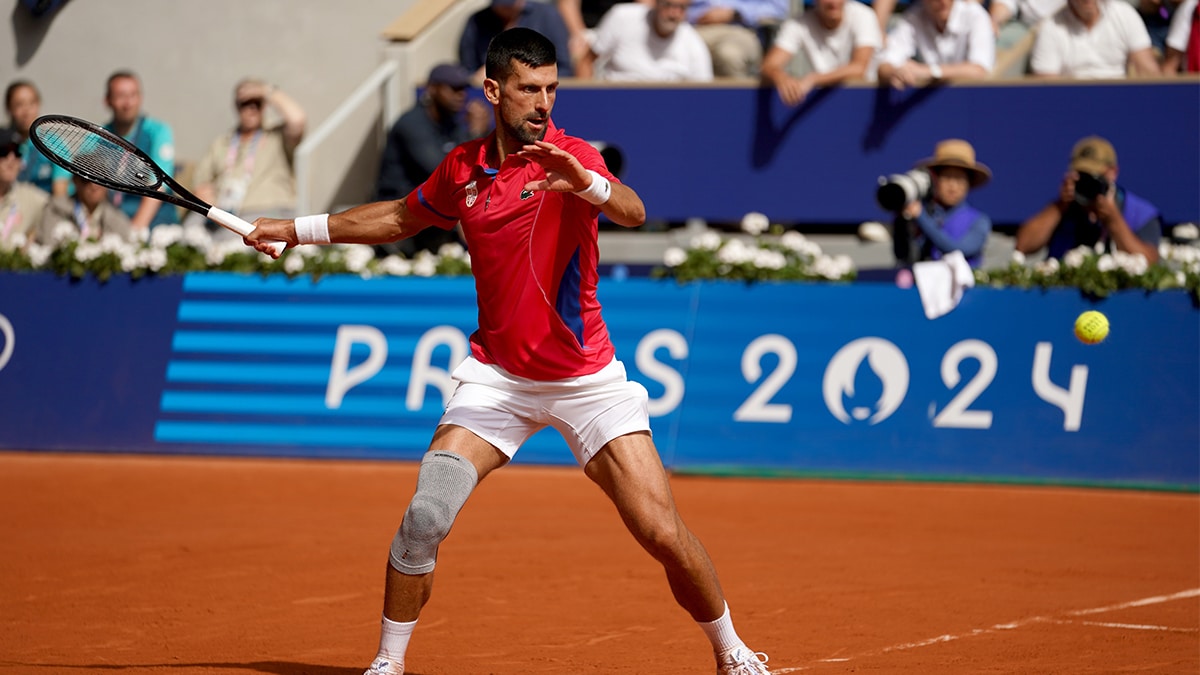 Novak Djokovic (SRB) returns a shot in the men’s singles gold medal match against Carlos Alcaraz (not pictured) during the Paris 2024 Olympic Summer Games at Stade Roland Garros