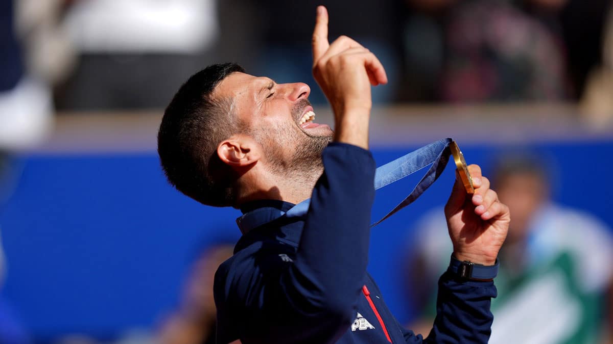 Aug 4, 2024; Paris, France; Novak Djokovic (SRB) celebrates after receiving his gold medal during the Paris 2024 Olympic Summer Games at Stade Roland Garros. Mandatory Credit: Amber Searls-USA TODAY Sports