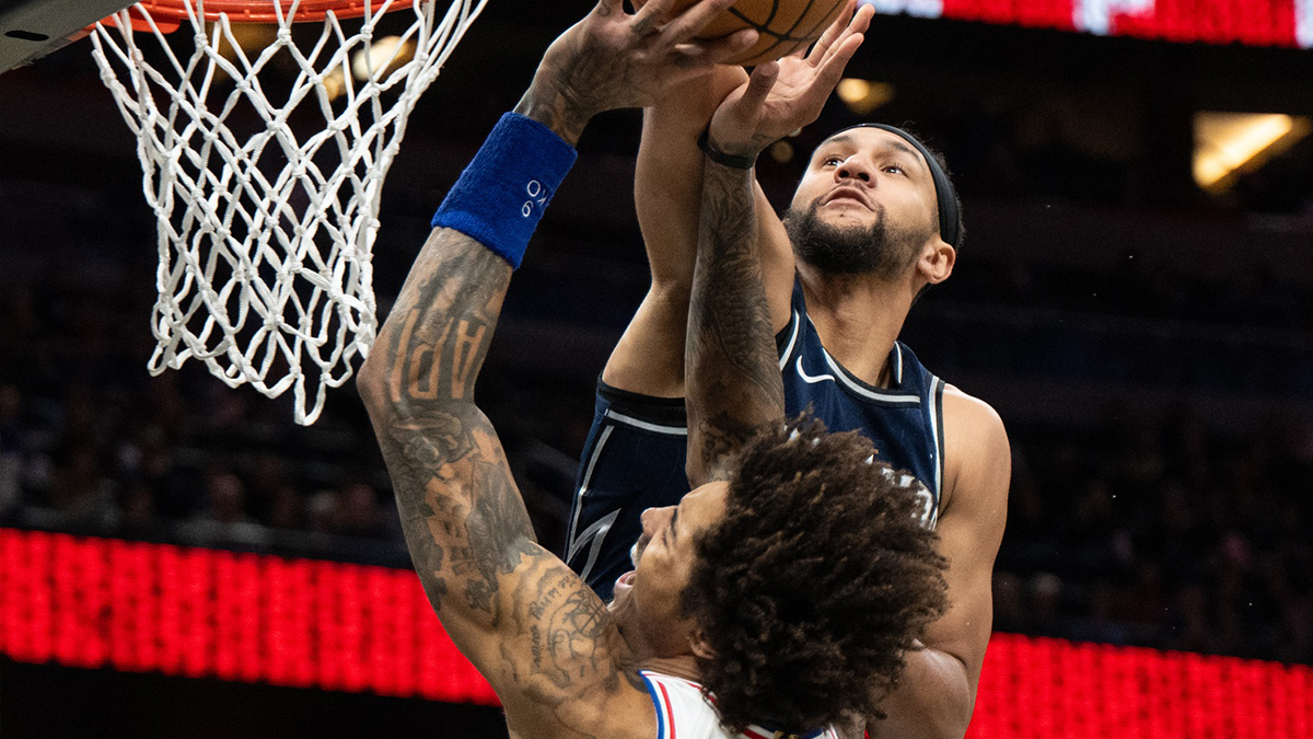 Orlando Magic guard Jalen Suggs (4) blocks a shot against Philadelphia 76ers small guard Kelly Oubre Jr. (9) in the first quarter at Kia Center.