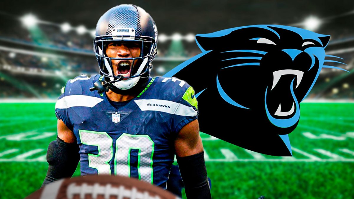 Seahawks' Michael Jackson in front of Panthers logo