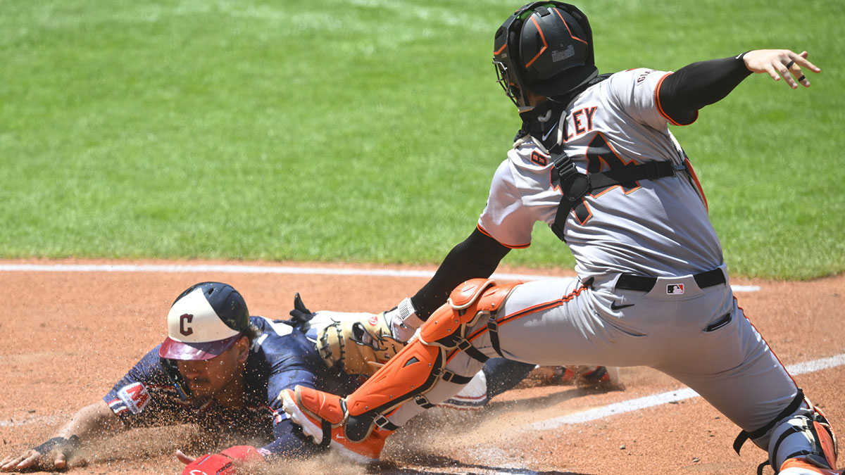 Jul 7, 2024; Cleveland, Ohio, USA; Cleveland Guardians first baseman Josh Naylor (22) is tagged out at home plate by San Francisco Giants catcher Patrick Bailey (14) in the fourth inning at Progressive Field.