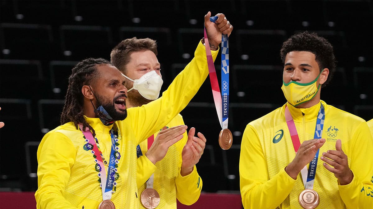 Team Australia point guard Patty Mills (5) celebrates with teammates after winning the bronze medal against the Slovenia during the Tokyo 2020 Olympic Summer Games at Saitama Super Arena.
