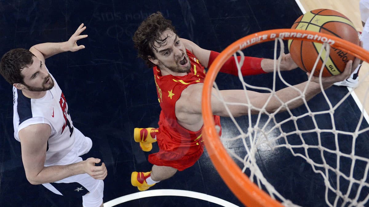 Spain forward Pau Gasol (right) shoots against USA forward Kevin Love (11) during the men's basketball gold medal game in the London 2012 Olympic Games at North Greenwich Arena.