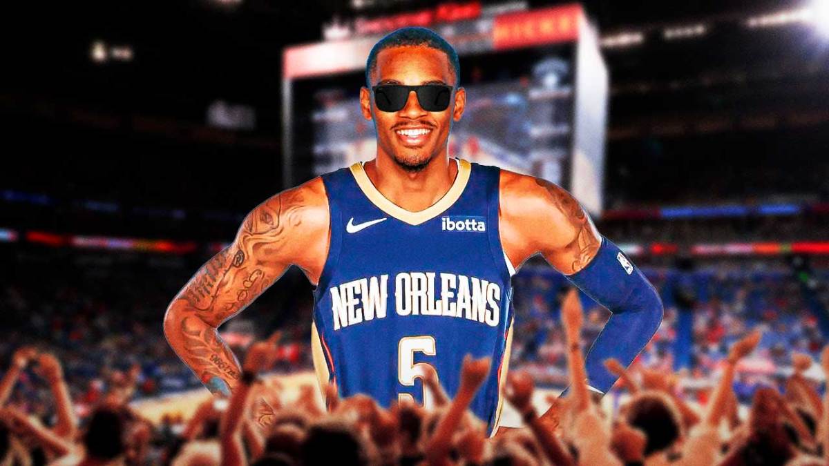 Dejounte Murray with a HUGE smile in sunglasses and smiling in the New Orleans Pelicans' Smoothie King Center