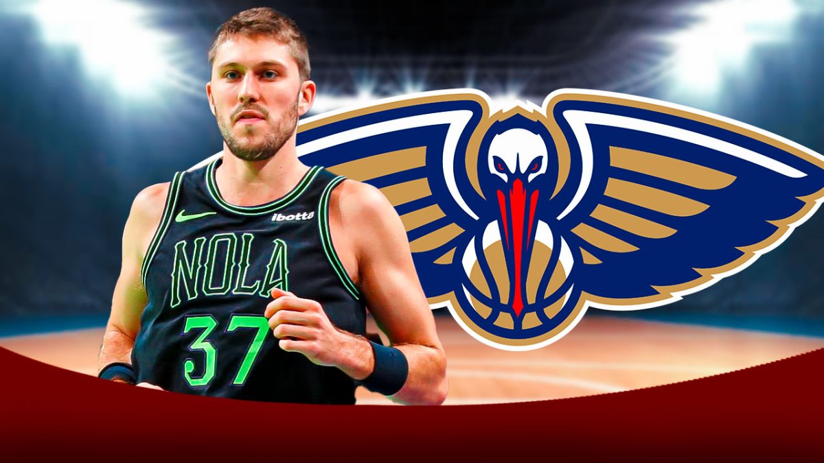 Pelicans guard Matt Ryan next to the New Orleans Pelicans logo