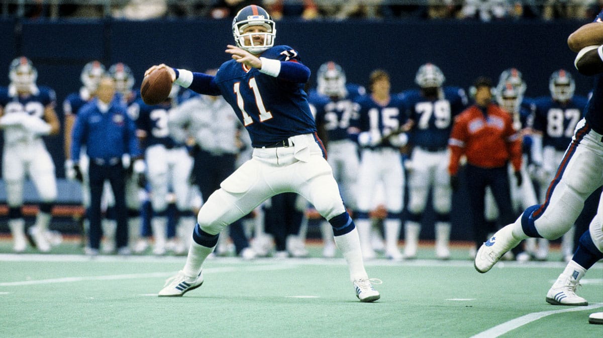 New York Giants quarterback Phil Simms (11) throws the ball against the St. Louis Cardinals at Giants Stadium during the 1985 season.