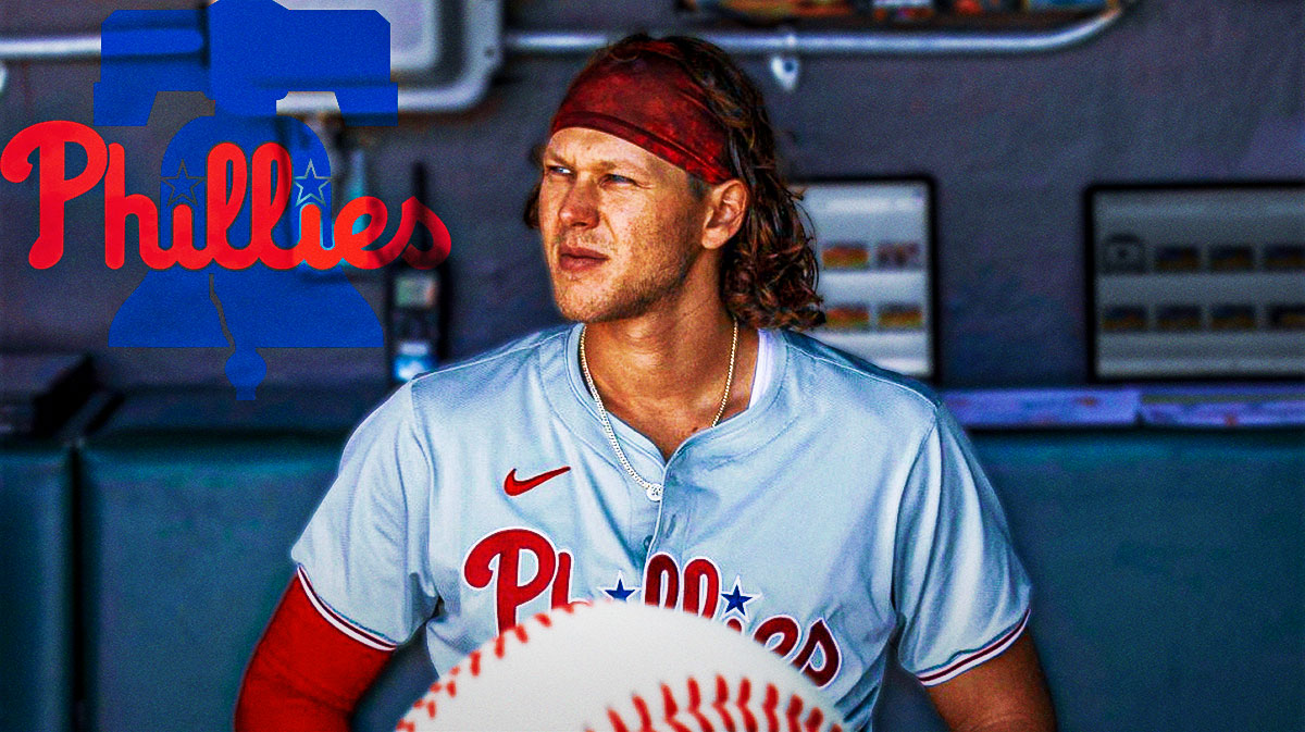 Phillies Alec Bohm sitting down in an MLB dugout looking serious.