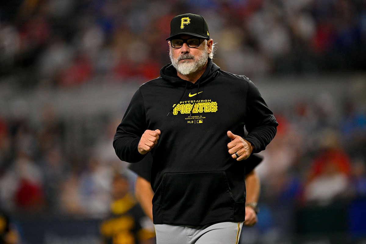 Pirates manager Derek Shelton (17) runs back to the doughnut during the game against the Texas Rangers at Globe Life Field.