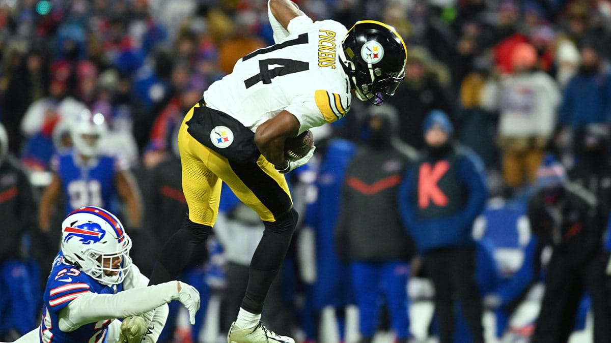 Jan 15, 2024; Orchard Park, New York, USA; Pittsburgh Steelers wide receiver George Pickens (14) escapes a tackle from Buffalo Bills safety Micah Hyde (23) in a 2024 AFC wild card game at Highmark Stadium. Mandatory Credit: Mark Konezny-USA TODAY Sports