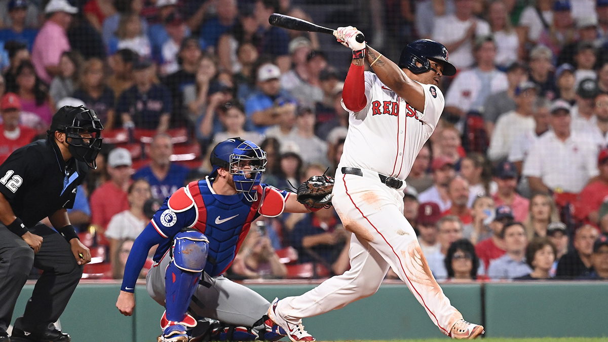 Boston Red Sox third baseman Rafael Devers (11) hits a single against the Texas Rangers during the fourth inning at Fenway Park.