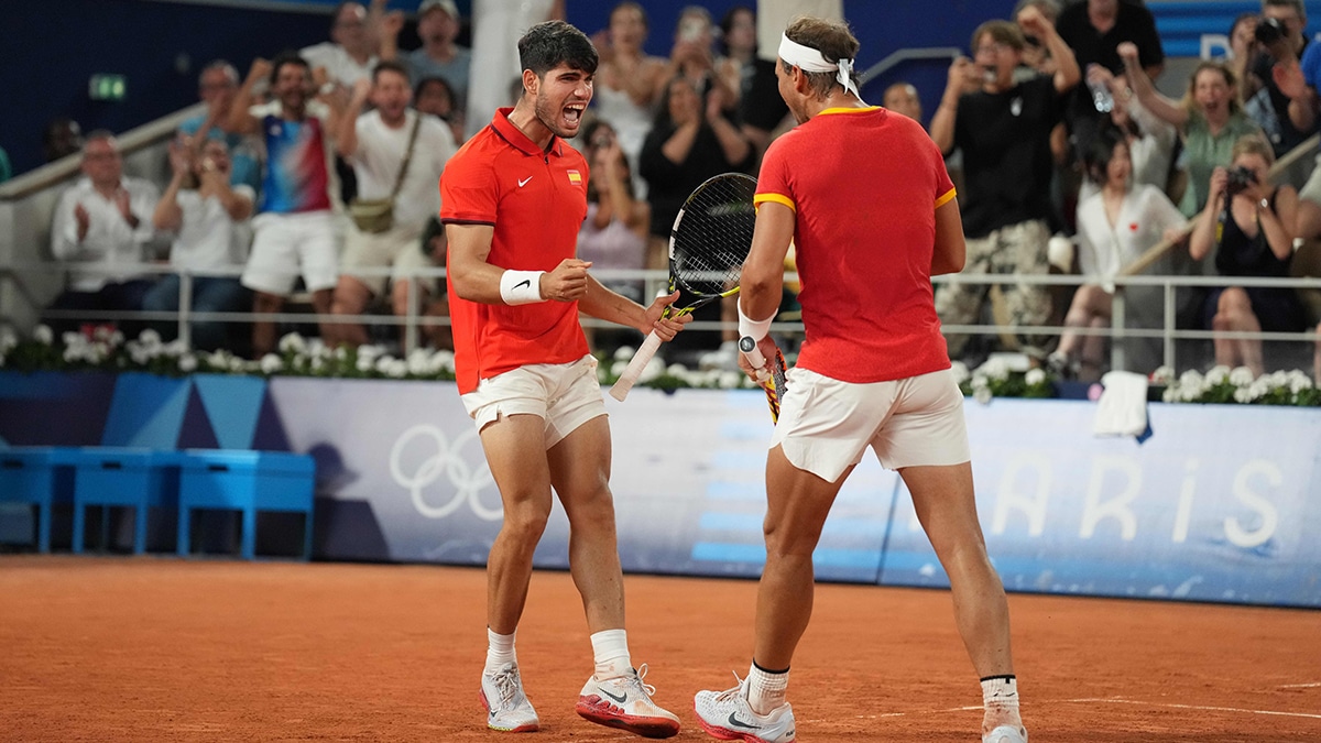 Jul 31, 2024; Paris, France; Rafael Nadal (ESP) and Carlos Alcaraz (ESP) celebrate in a men's doubles quarterfinal tennis match during the Paris 2024 Olympic Summer Games at Stade Roland Garros. Mandatory Credit: Kirby Lee-USA TODAY Sports