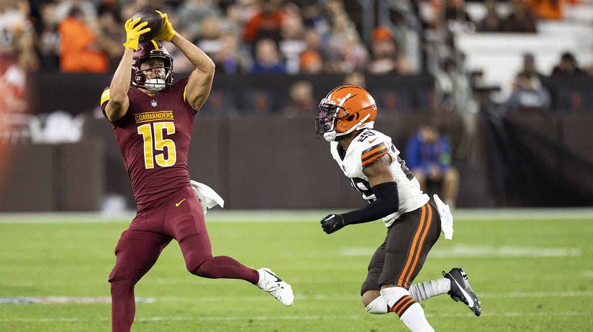 Washington Commanders wide receiver Dax Milne (15) makes a reception under coverage by Cleveland Browns cornerback Cameron Mitchell (29) during the third quarter at Cleveland Browns Stadium. 