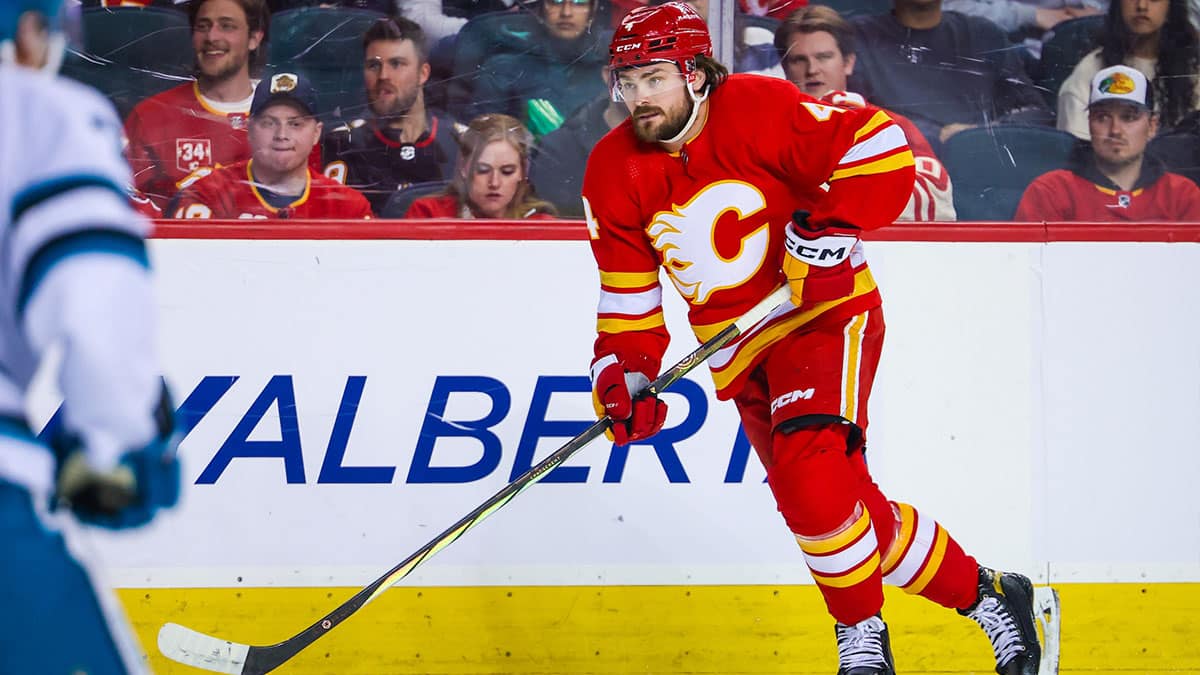 Calgary Flames defenseman Rasmus Andersson (4) skates with the puck against the San Jose Sharks during the second period at Scotiabank Saddledome.