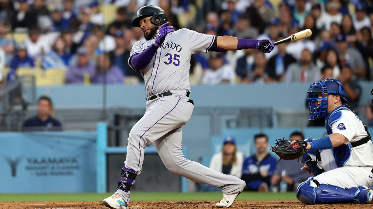 Colorado Rockies catcher Elias Diaz (35) hits a single during the third inning against the Los Angeles Dodgers at Dodger Stadium.