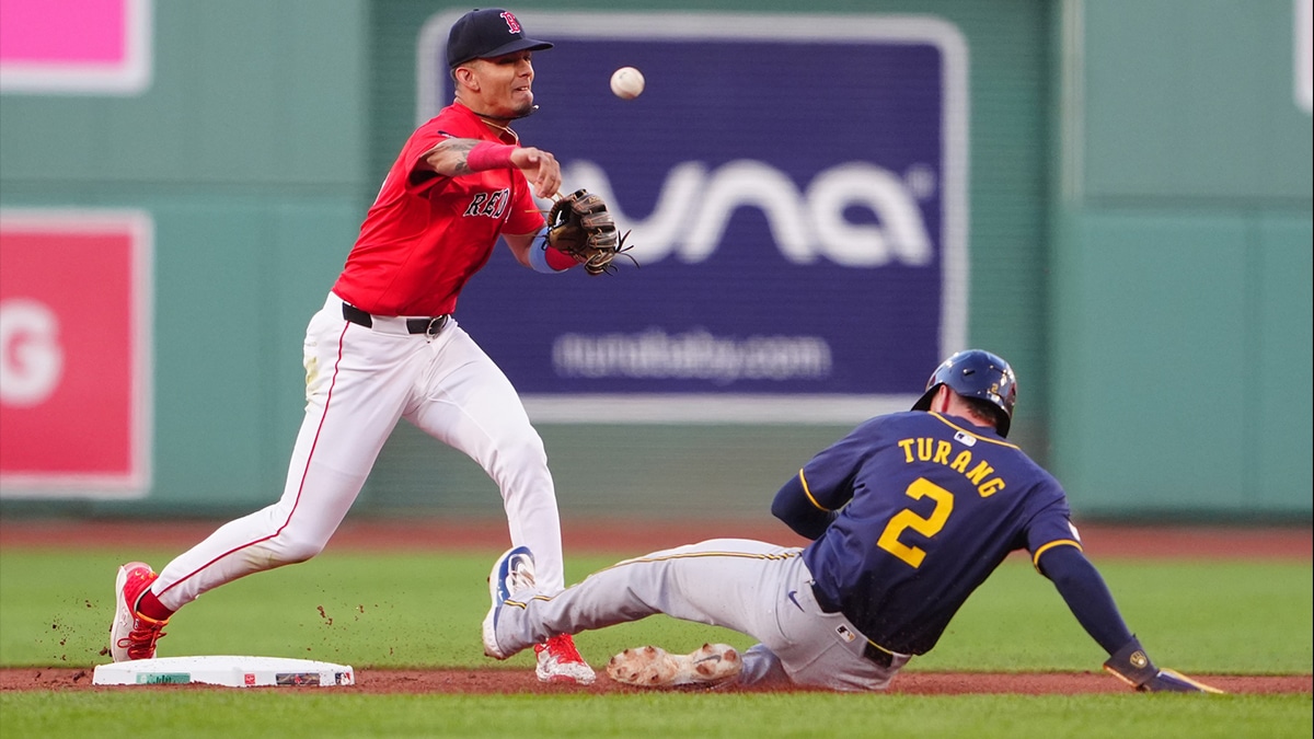 Boston Red Sox second baseman Vaughn Grissom (5) turns a double play with Milwaukee Brewers second baseman Brice Turang (2) sliding into second base during the first inning at Fenway Park. 