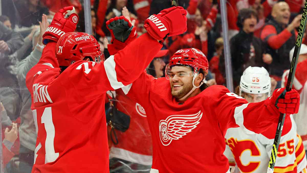 Detroit Red Wings center Dylan Larkin (71) celebrates with right wing Alex DeBrincat (93) after scoring in the second period against the Calgary Flames at Little Caesars Arena.