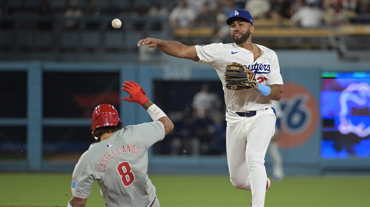 Philadelphia Phillies right fielder Nick Castellanos (9) is out at second base when Los Angeles Dodgers right fielder Amed Rosario (27) throws a ball to first base for a double play in the eighth inning at Dodger Stadium. 