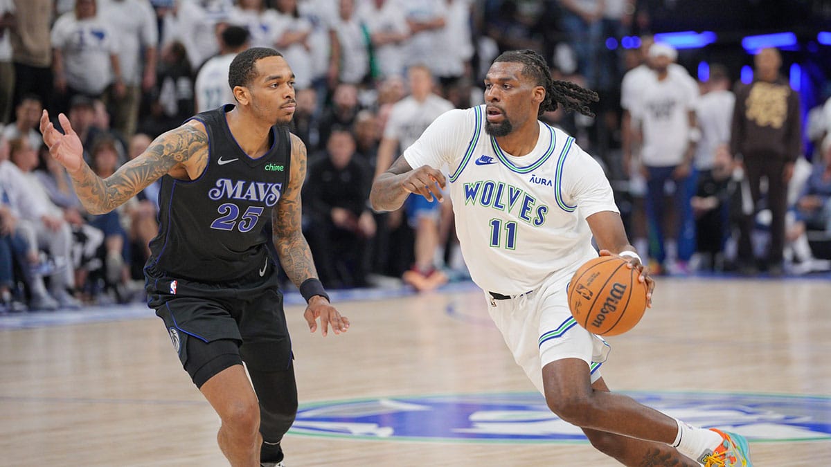 Minnesota Timberwolves center Naz Reid (11) controls the ball against Dallas Mavericks forward P.J. Washington (25) in the fourth quarter during game two of the western conference finals for the 2024 NBA playoffs at Target Center. 