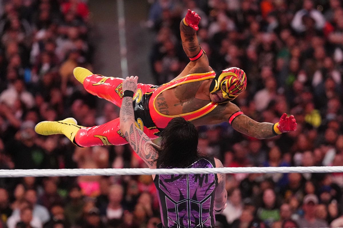 Rey Mysterio in a WWE match with his son Dom
