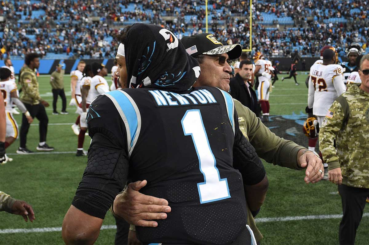 Washington Football Team head coach Ron Rivera with Carolina Panthers quarterback Cam Newton (1) after the game at Bank of America Stadium.