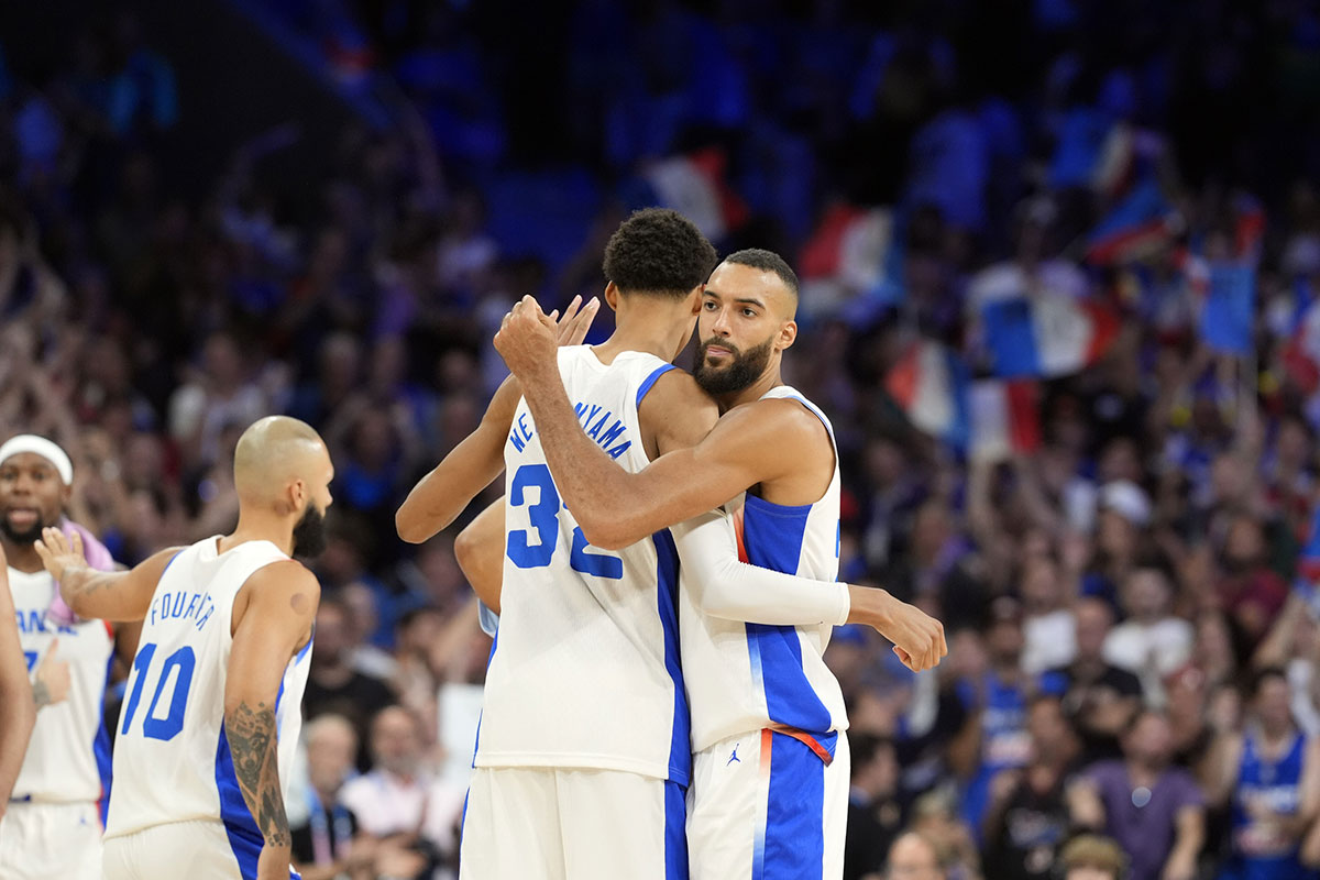 France power forward Victor Wembanyama (32) embraces centre Rudy Gobert (27) after the game against Brazil during the Paris 2024 Olympic Summer Games at Stade Pierre-Mauroy.