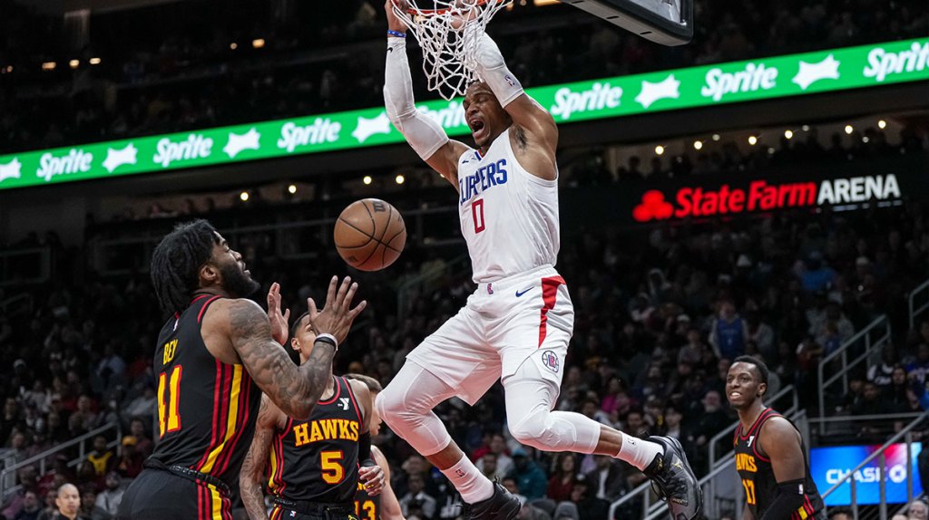 LA Clippers guard Russell Westbrook (0) dunks behind Atlanta Hawks guard Dejounte Murray (5) and forward Saddiq Bey (41) during the second half at State Farm Arena.