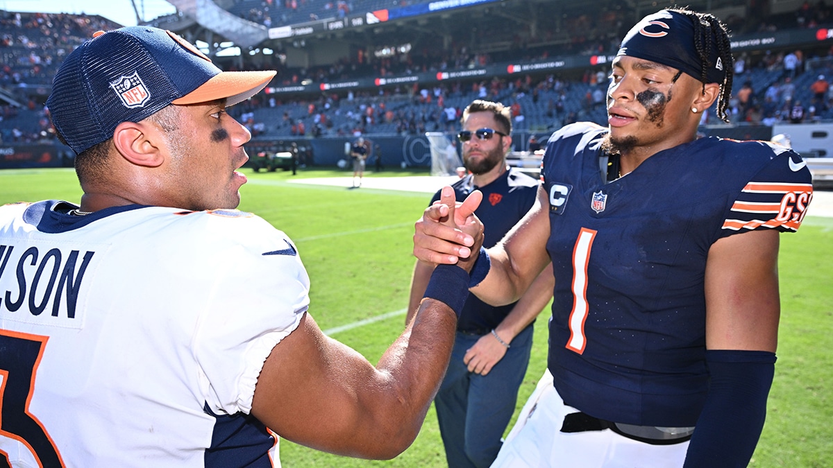 Chicago Bears quarterback Justin Fields (1), right, meets with Denver Broncos quarterback Russell Wilson (3) at midfield after their game at Soldier Field.