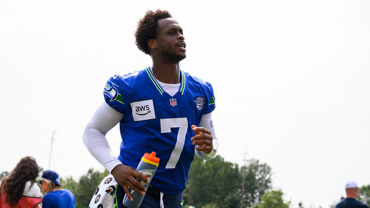 Jul 27, 2024; Renton, WA, USA; Seattle Seahawks quarterback Geno Smith (7) jogs off the field after training camp at Virginia Mason Athletic Center. Mandatory Credit: Steven Bisig-USA TODAY Sports