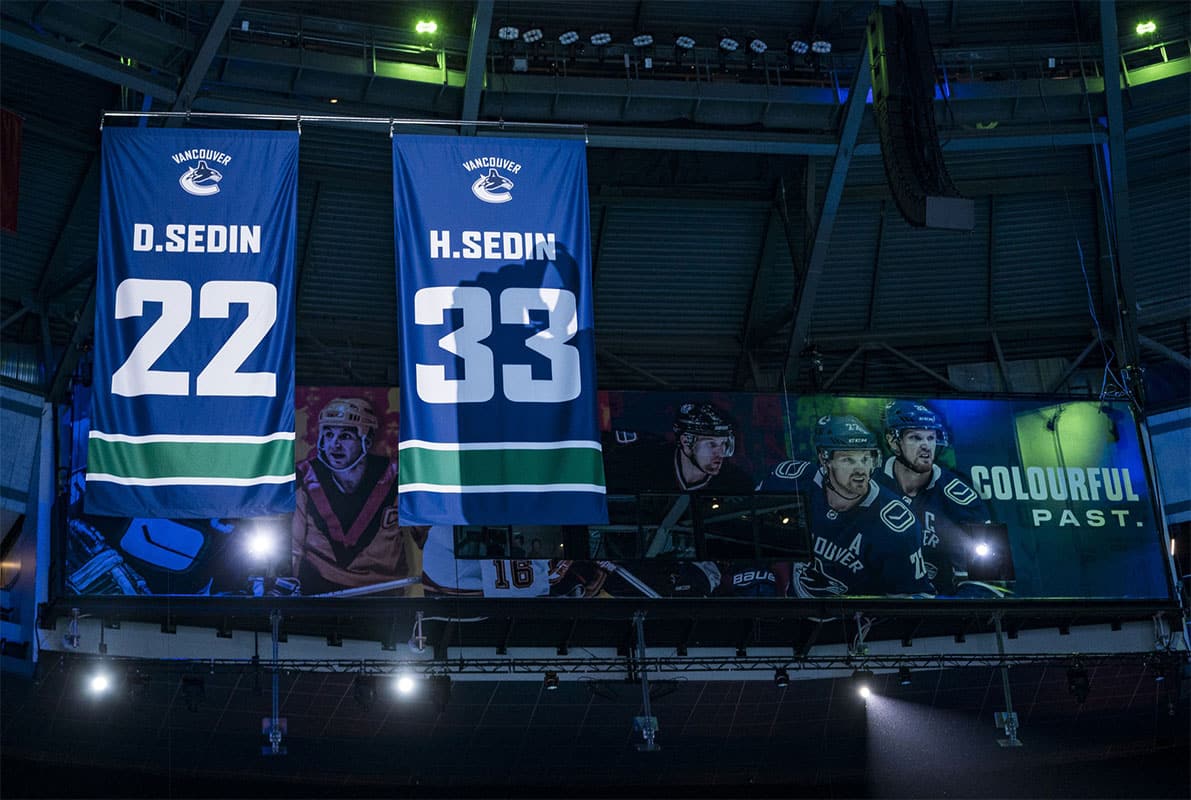 Twin brothers Daniel Sedin (22) and Henrik Sedin (33) of Sweden have their Vancouver Canucks jerseys retired to the rafters of Rogers Arena in a ceremony prior to a game between the Vancouver Canucks and Chicago Blackhawks.