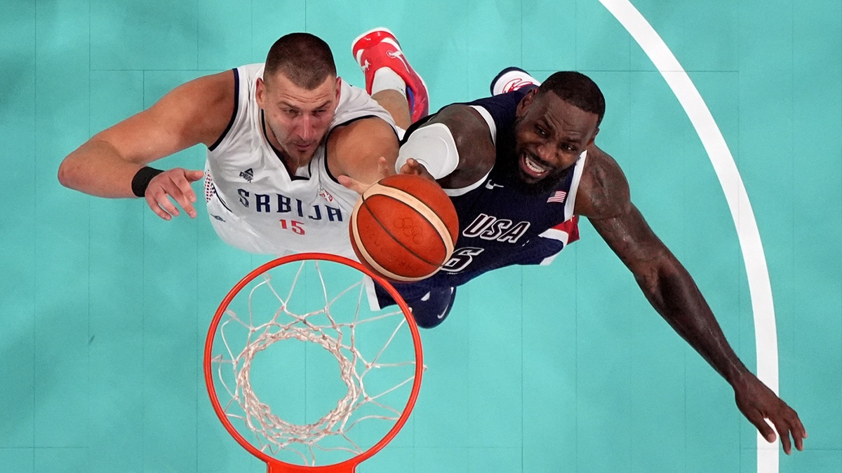 Serbia power forward Nikola Jokic (15) and United States guard Lebron James (6) jump for a rebound in the fourth quarter during the Paris 2024 Olympic Summer Games at Stade Pierre-Mauroy