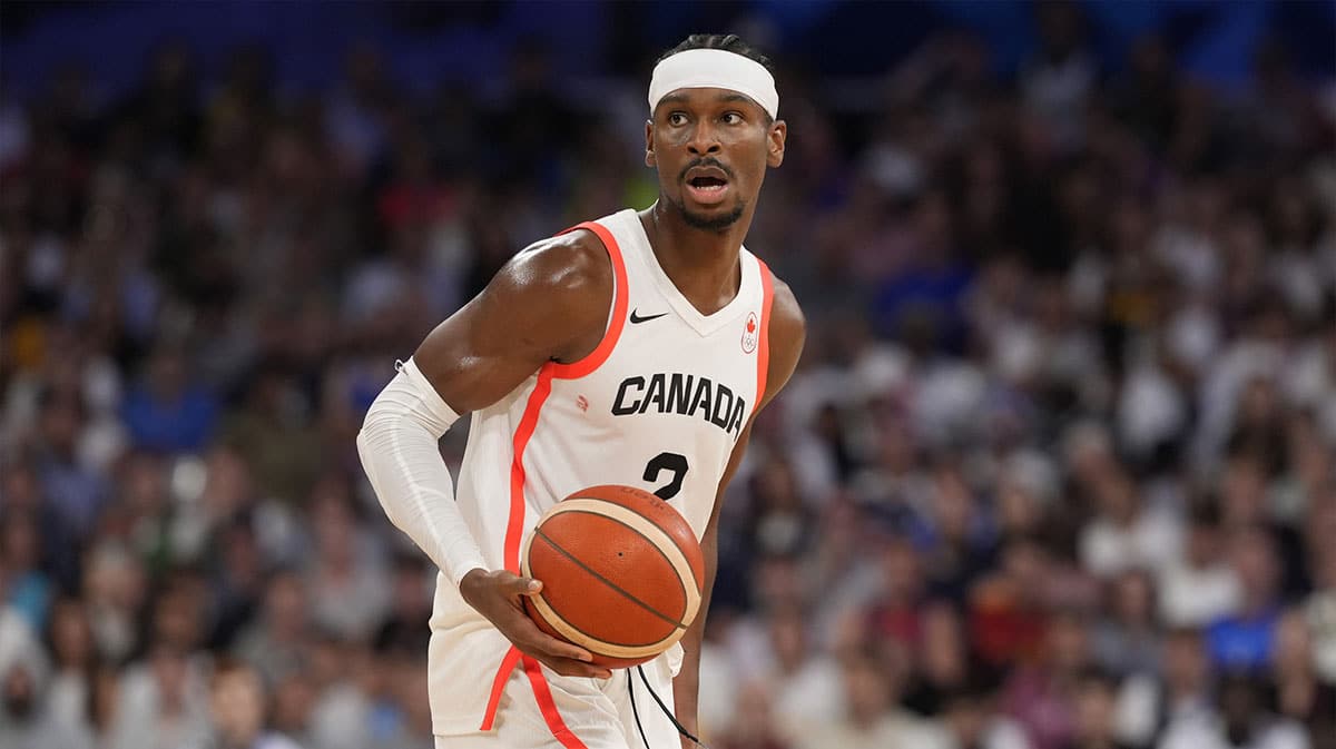 Canada guard Shai Gilgeous-Alexander (2) controls the ball in the second half against Spain in a men’s group A basketball game during the Paris 2024 Olympic Summer Games at Stade Pierre-Mauroy.