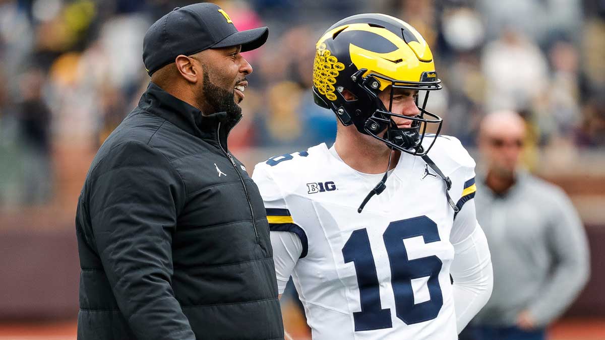 Michigan head coach Sherrone Moore talks to quarterback Davis Warren (16) at warmup during the spring game at Michigan Stadium in Ann Arbor on Saturday, April 20, 2024.