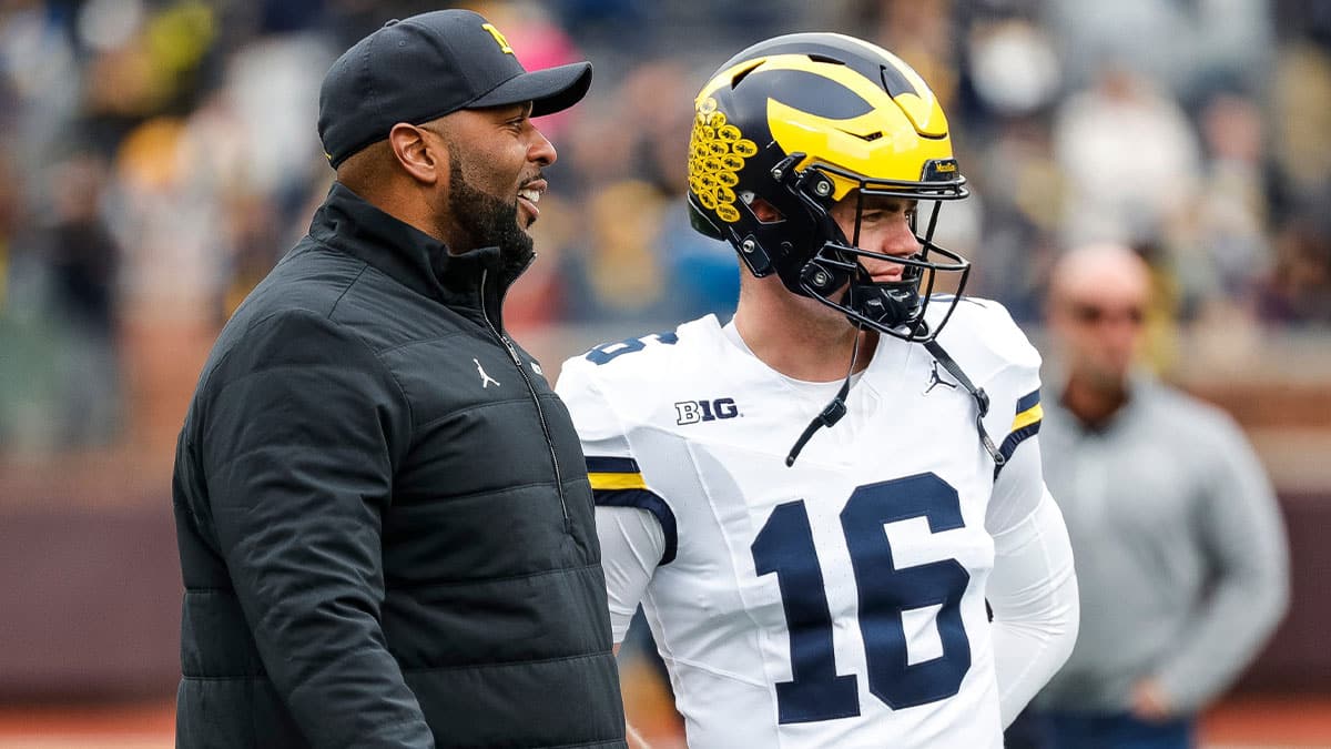 Michigan head coach Sherrone Moore talks to quarterback Davis Warren (16) at warmup during the spring game at Michigan Stadium