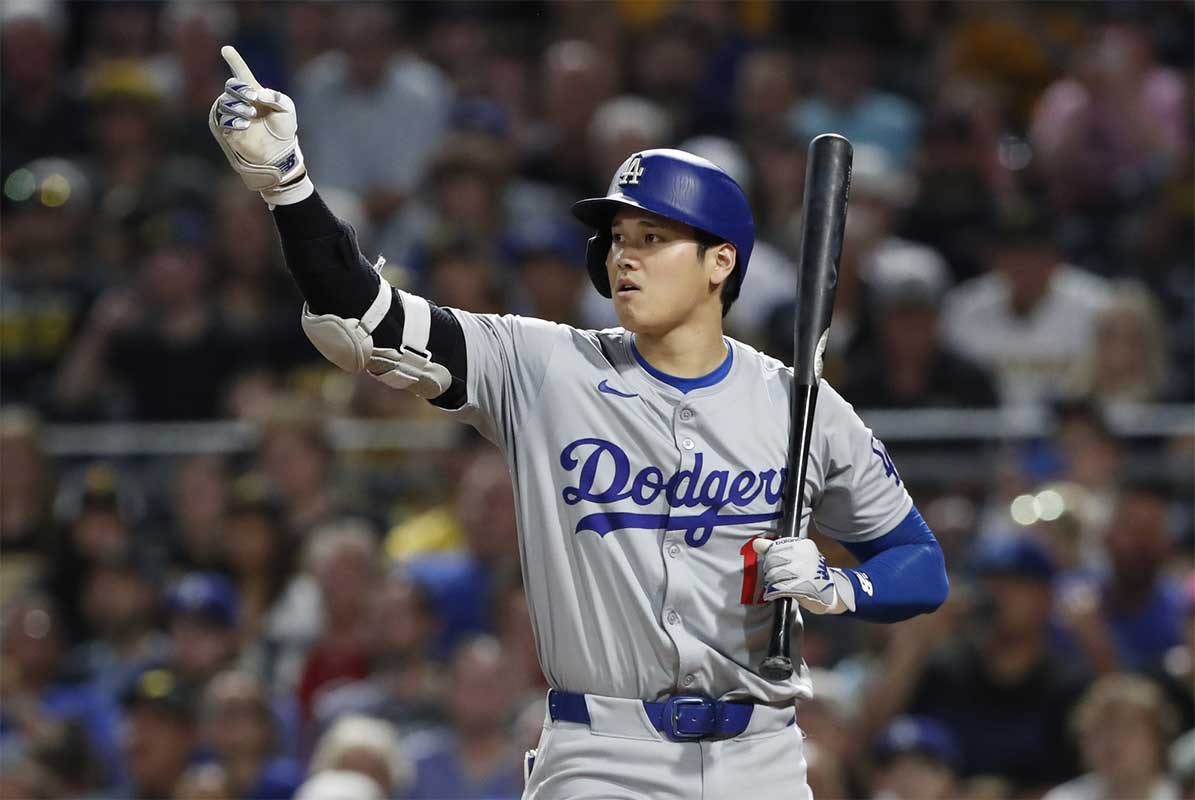 Los Angeles Dodgers designated hitter Shohei Ohtani (17) gestures for a base runner to advance on a wild pitch from the Pittsburgh Pirates during the eighth inning at PNC Park.