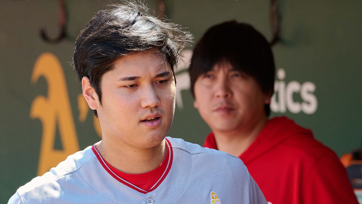 Los Angeles Angels designated hitter Shohei Ohtani (17) and interpreter Ippei Mizuhara stand in the dugout before the game between the Los Angeles Angels and the Oakland Athletics at Oakland-Alameda County Coliseum. 