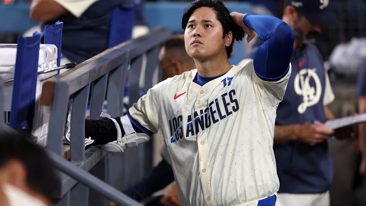 Los Angeles Dodgers designated hitter Shohei Ohtani (17) looks on in the dugout during the MLB baseball game against the Pittsburgh Pirates at Dodger Stadium.