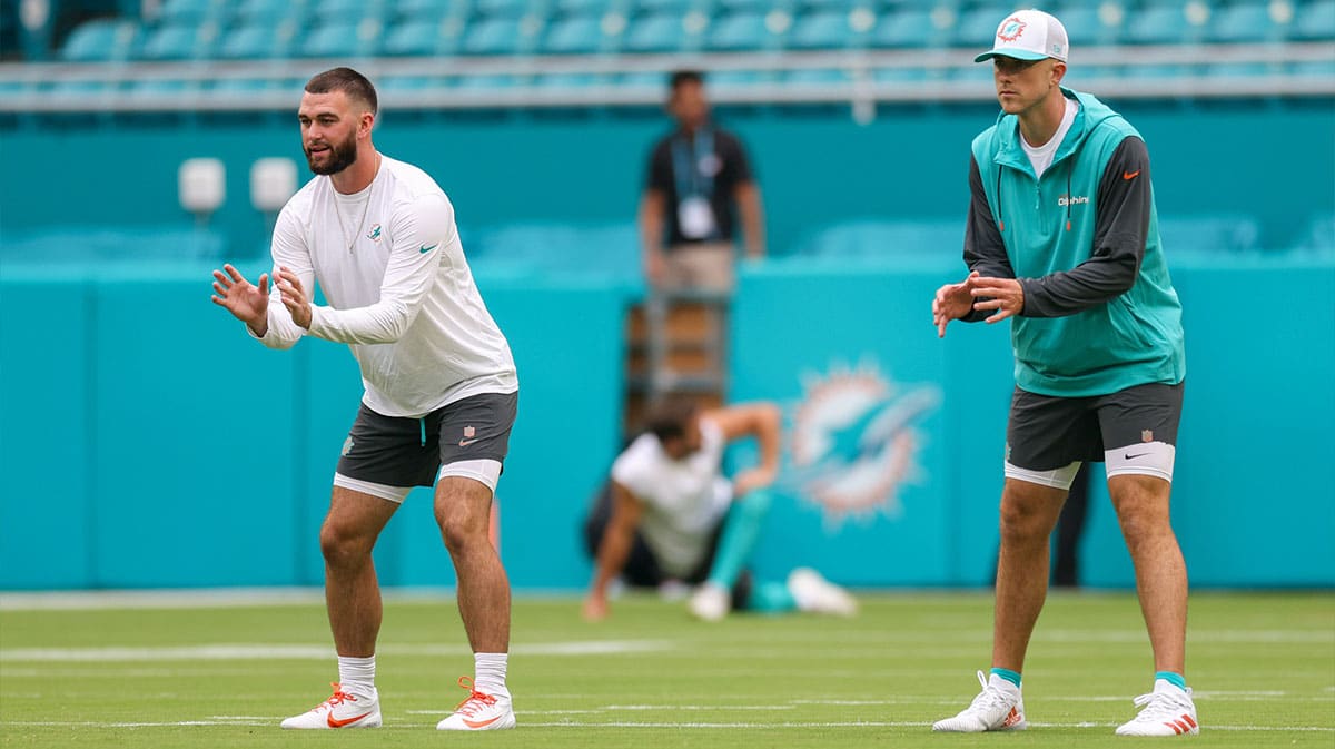 Miami Dolphins quarterback Mike White (14) and quarterback Skylar Thompson (19) warms up before a preseason game against the Atlanta Falcons at Hard Rock Stadium.