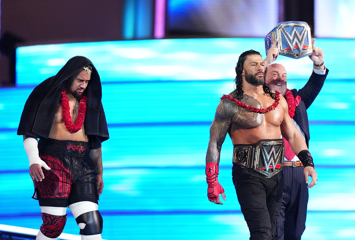 Solo Sikoa following Roman Reigns and Paul Heyman at WrestleMania 39 during Reigns' entrance