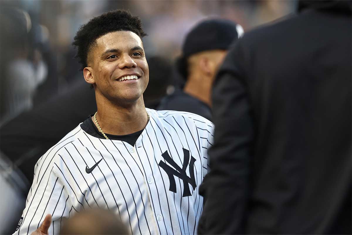 New York Yankees right fielder Juan Soto (22) celebrates in the dugout after hitting a two run home run in the first inning against the Cleveland Guardians at Yankee Stadium.