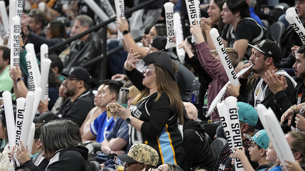 San Antonio Spurs fans wave footballs during the second half against the Minnesota Timberwolves at Frost Bank Center.