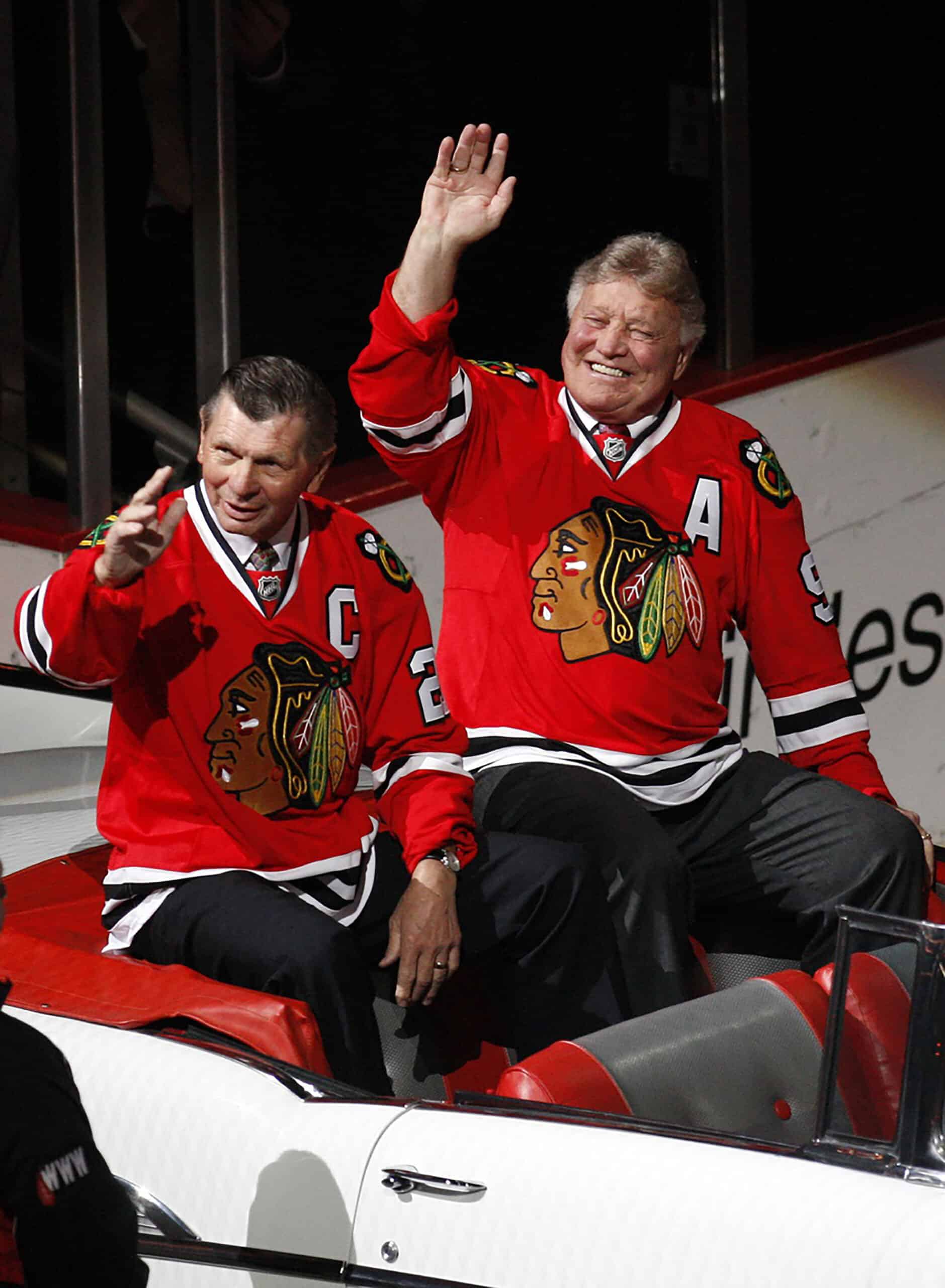 Chicago Blackhawks former players Stan Mikita (21) and Bobby Hull (9) wave to the crowd as they are introduced during a ceremony honoring their careers before the game against the San Jose Sharks at the United Center.