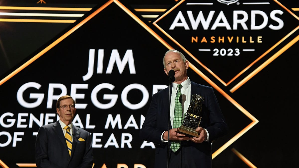 Dallas Stars general manager Jim Nill is awarded the Jim Gregory General Manager of the Year award by Nashville Predators general manager David Poile during the first round of the 2023 NHL Draft at Bridgestone Arena.