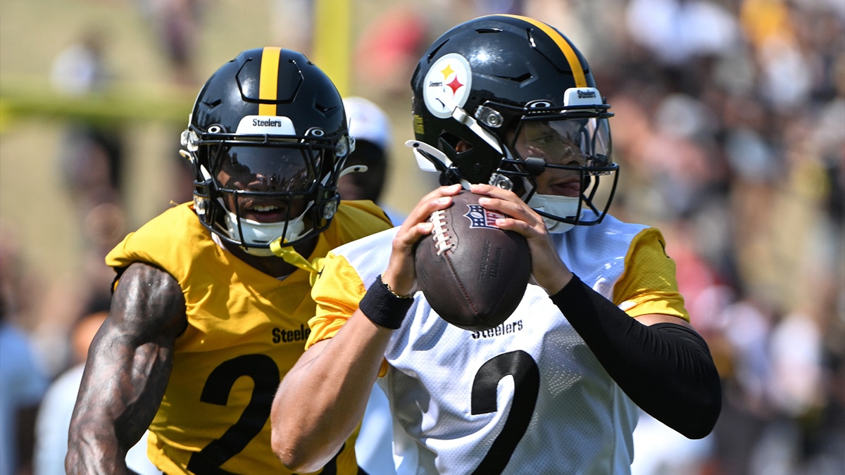  Pittsburgh Steelers quarterback Justin Fields (2) is pressured by safety DeShon Elliott (25) during training camp at Saint Vincent College.