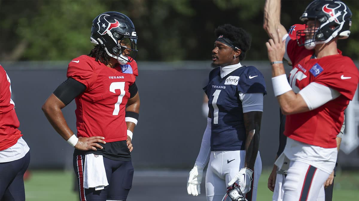 Houston Texans quarterback C.J. Stroud (7) and wide receiver Stefon Diggs (1) talk during training camp at Houston Methodist Training Center.